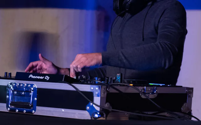 DJ aux platines sous un éclairage bleu pendant une soirée