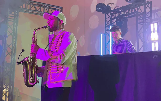 Saxophoniste et DJ sur scène pendant une soirée